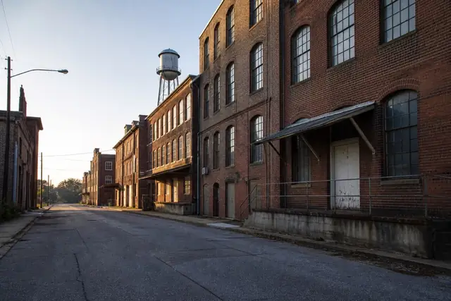 Brick industrial buildings and mature trees in High Point's Furniture City landscape