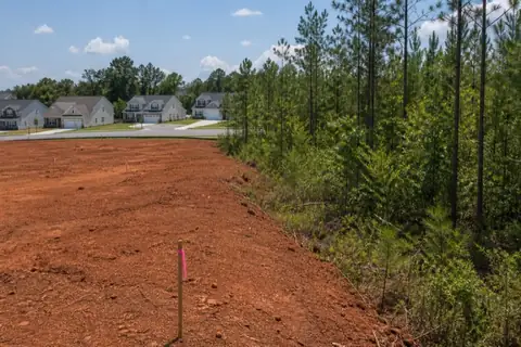 Surveyed High Point building lot being opened between retained hardwoods and red Piedmont soil